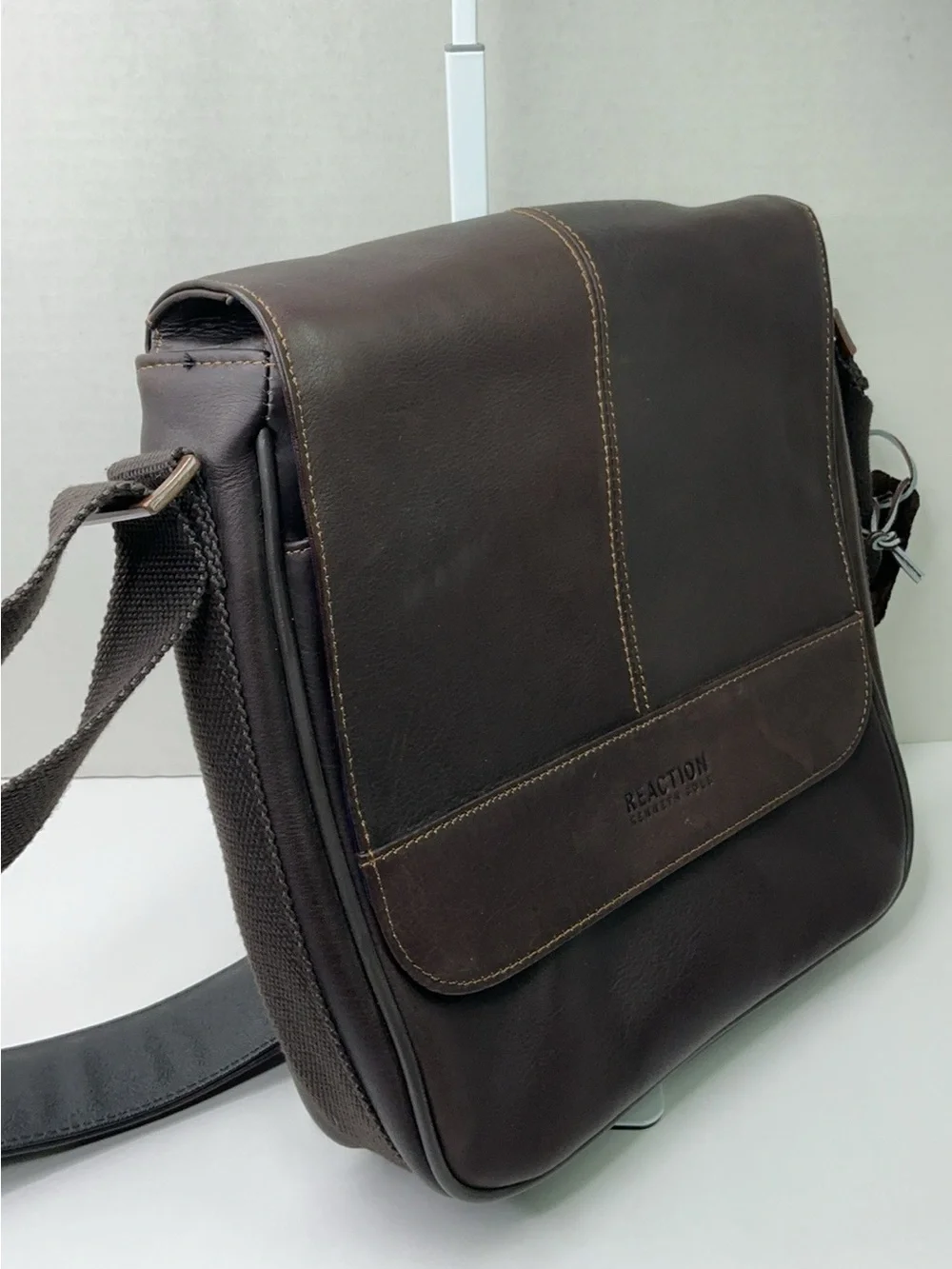 Kenneth Cole Reaction dark brown leather messenger-style tablet bag.